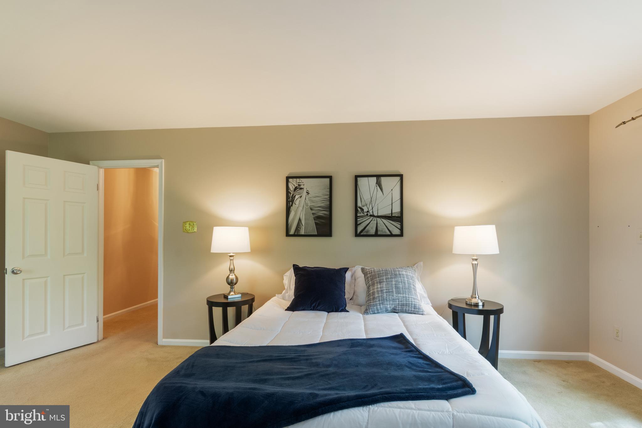 4036 Roop Road New Windsor, MD 21776 - Photo 26 of 55 a bedroom with a bed and a lamp