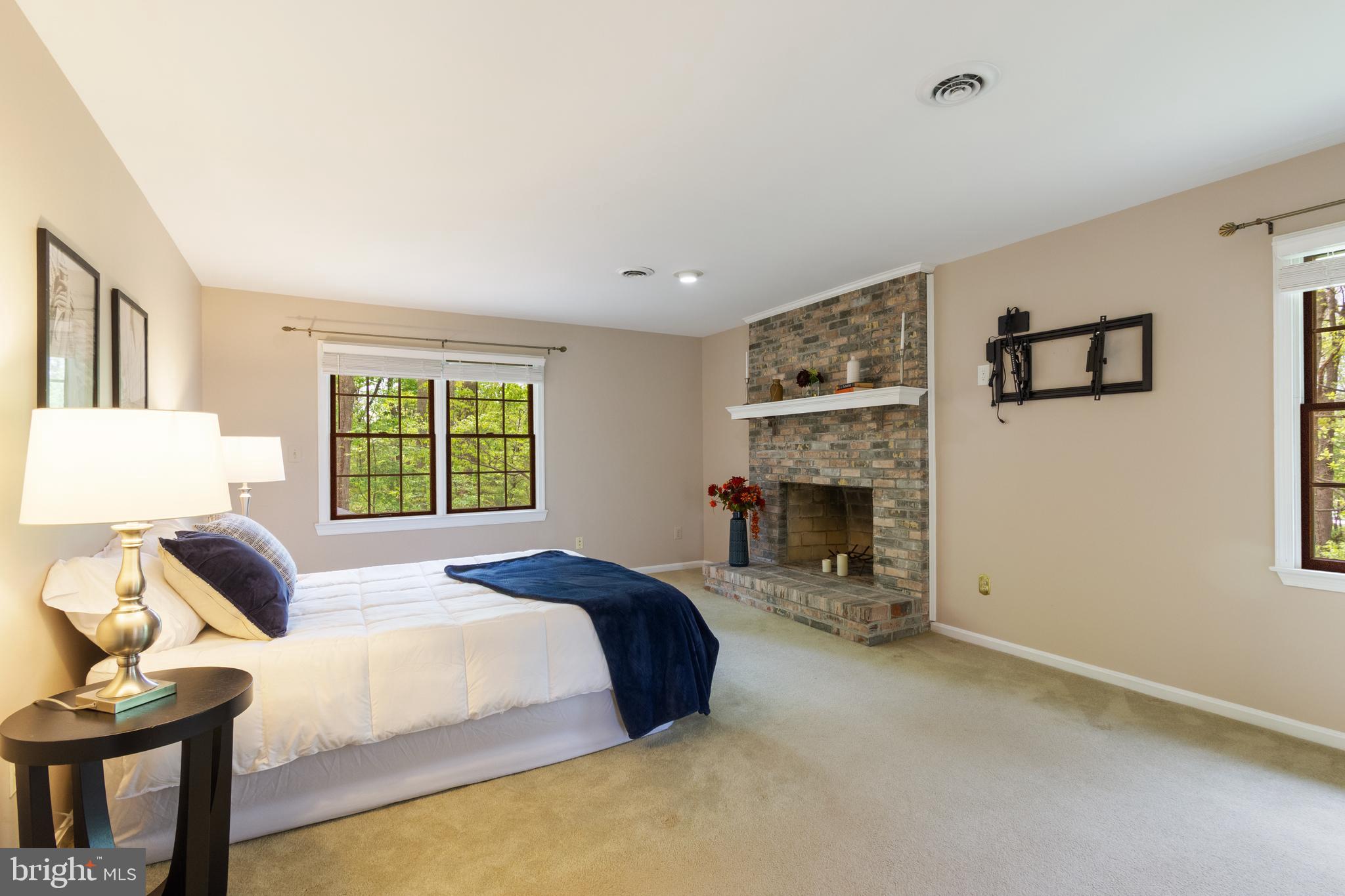 4036 Roop Road New Windsor, MD 21776 - Photo 28 of 55 a spacious bedroom with a bed and a fireplace