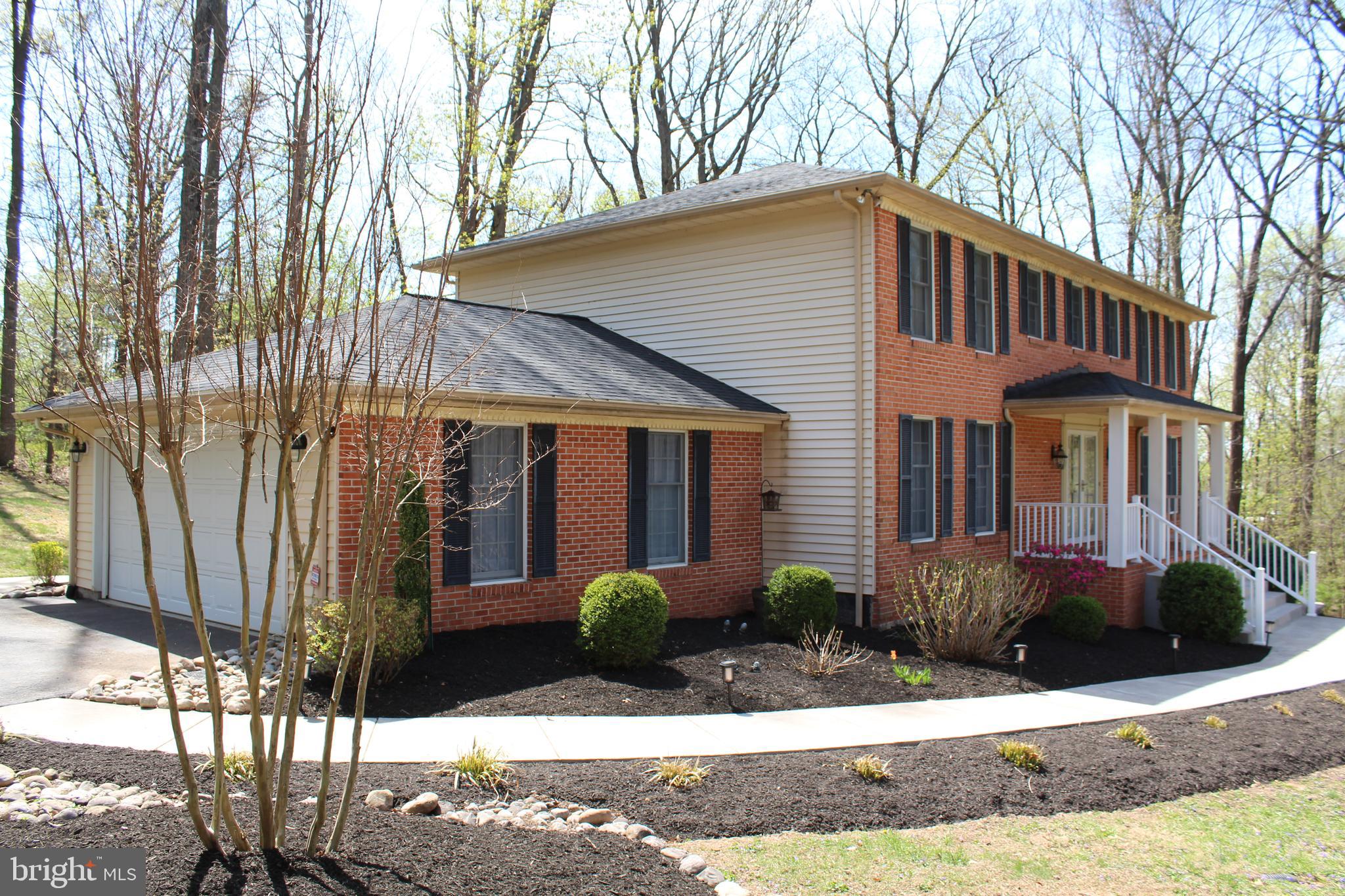 4036 Roop Road New Windsor, MD 21776 - Photo 3 of 55 a front view of a house with yard and glass windows