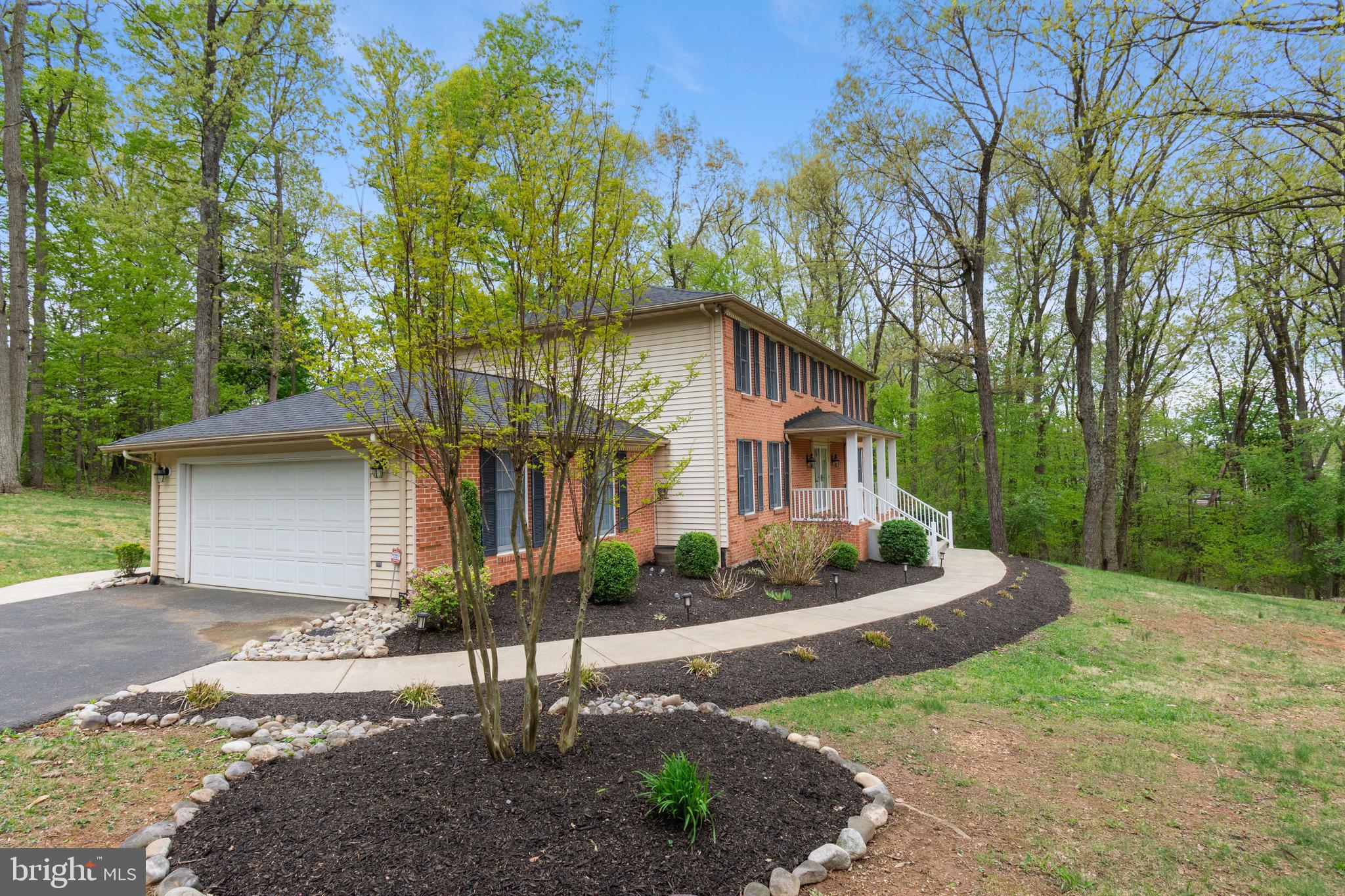 4036 Roop Road New Windsor, MD 21776 - Photo 4 of 55 a front view of a house with a yard and tree s