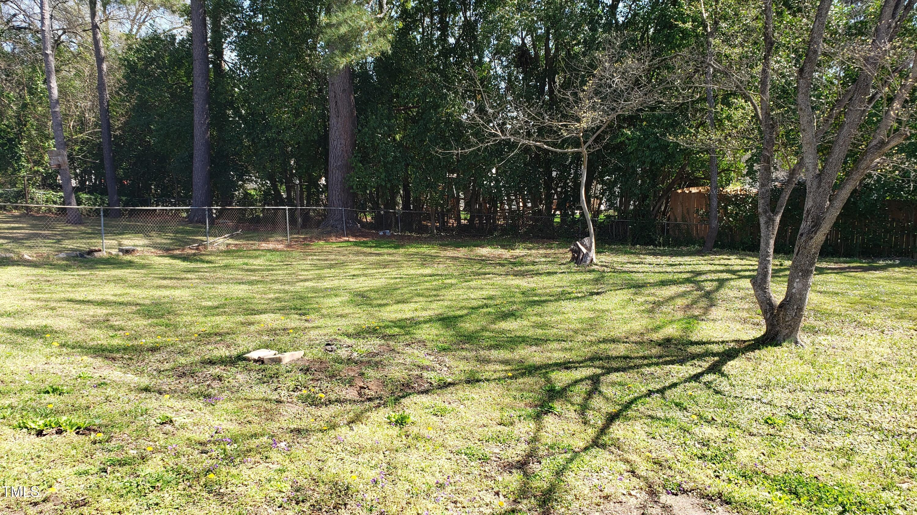 2739 Layden Street Raleigh, NC 27603 - Photo 2 of 10 a swimming pool that has lawn chairs and wooden fence