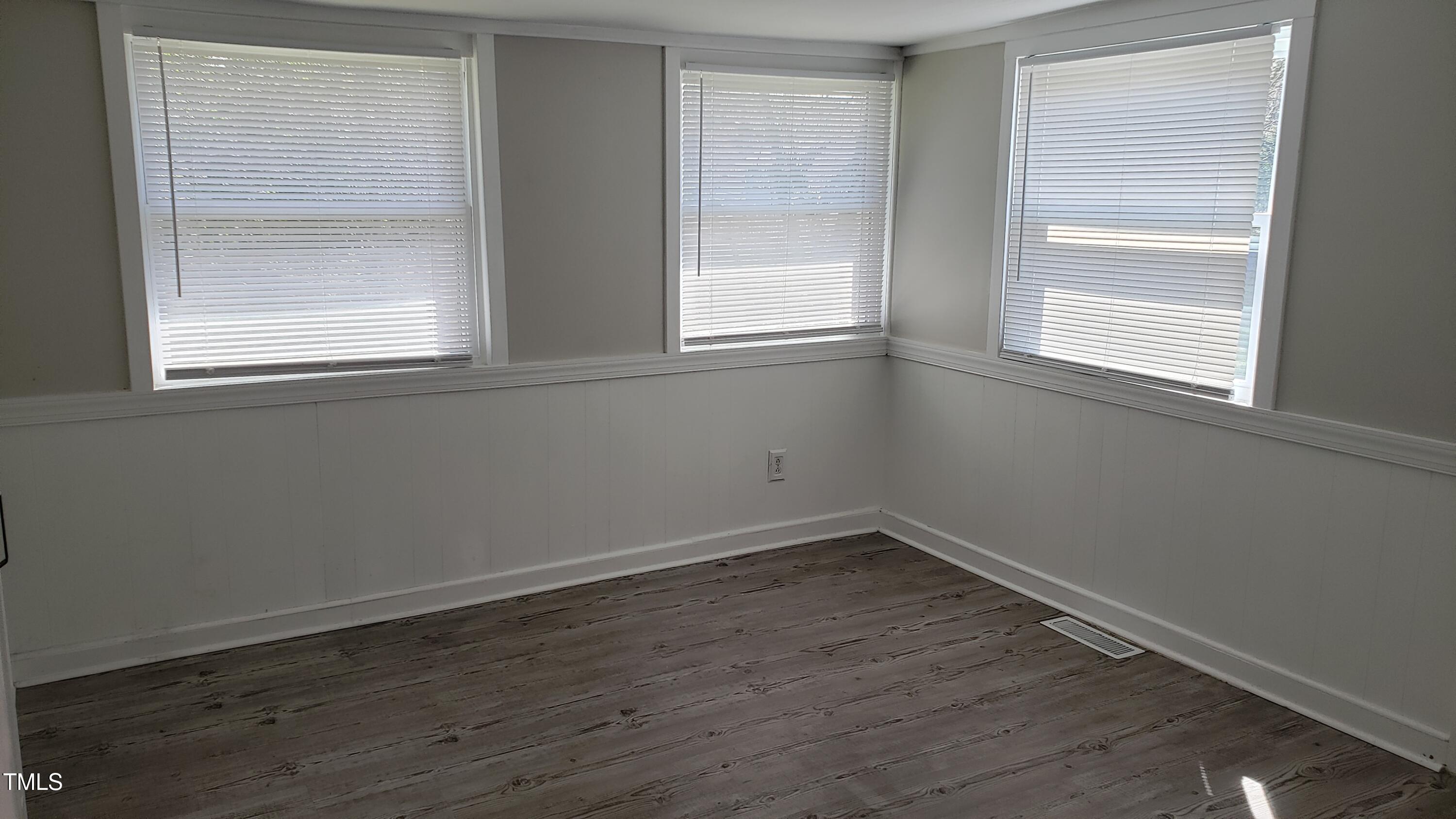 2739 Layden Street Raleigh, NC 27603 - Photo 8 of 10 a view of an empty room with wooden floor and a window