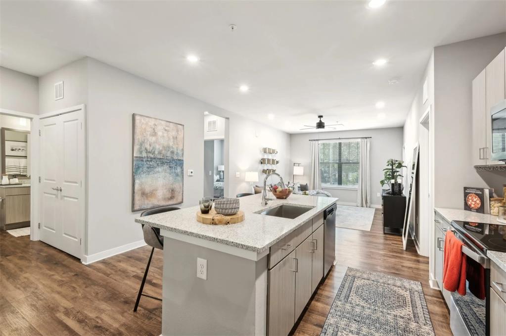 2201 Northwest Federal Highway, Unit 2B1314 Stuart, FL 34994 - Photo 1 of 47 a kitchen that has a sink a stove and chairs
