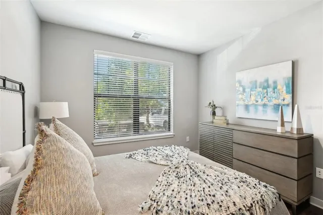 a bedroom with a bed and a window