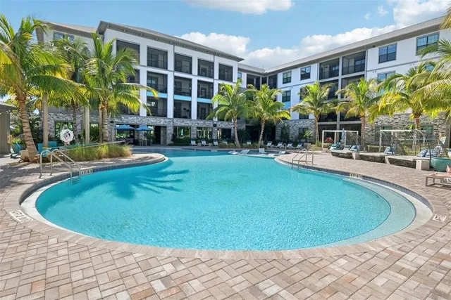 a swimming pool with outdoor seating and yard