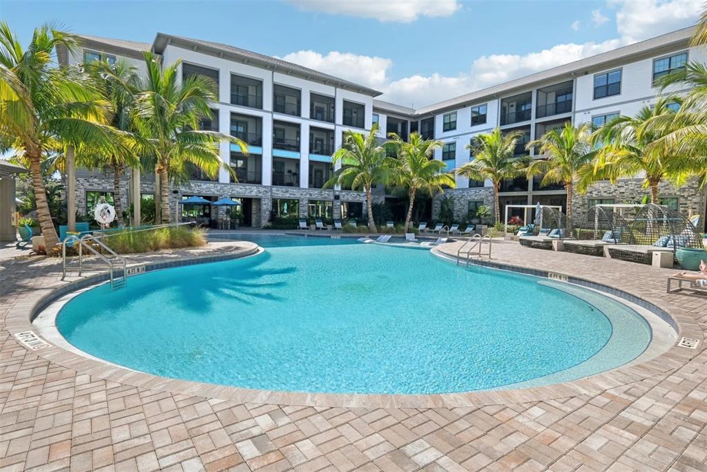 2201 Northwest Federal Highway, Unit 2B1314 Stuart, FL 34994 - Photo 32 of 47 a swimming pool with outdoor seating and yard