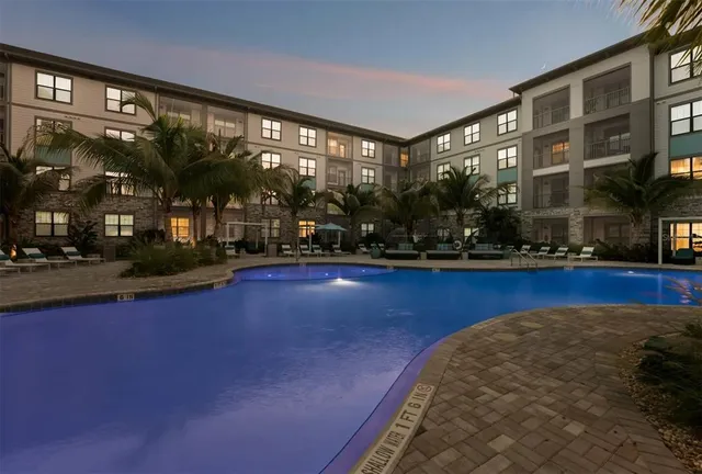 a view of a patio with swimming pool table and chairs