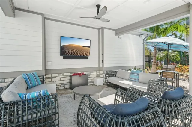 a view of a patio with table and chairs under an umbrella
