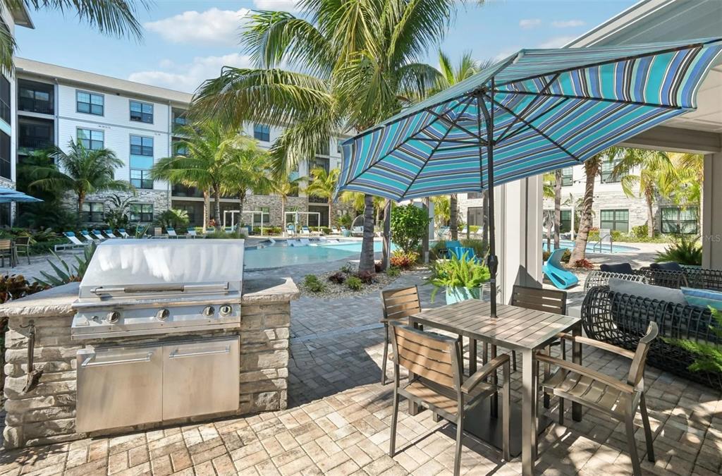 2201 Northwest Federal Highway, Unit 2B1314 Stuart, FL 34994 - Photo 40 of 47 a view of a patio with table and chairs under an umbrella
