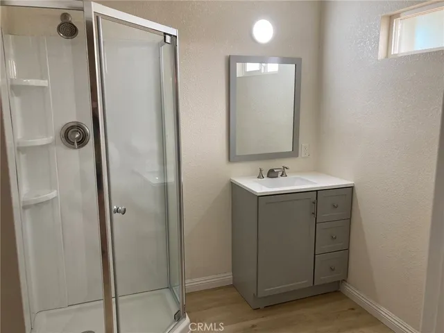 a bathroom with a shower sink and mirror