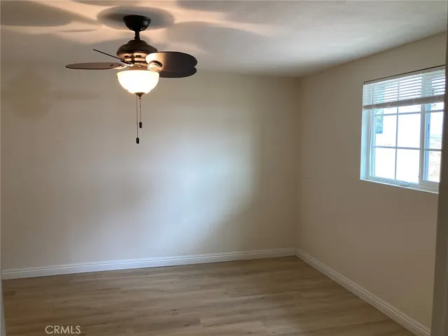 a view of room with a window and wooden floor