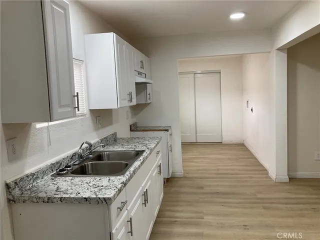 a kitchen that has a sink and a stove in it