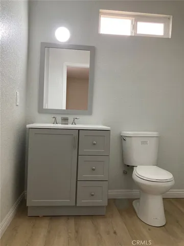 a bathroom with a sink a toilet and mirror