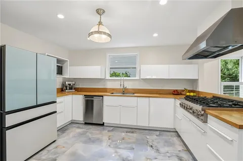 a kitchen with stainless steel appliances granite countertop a sink and a stove