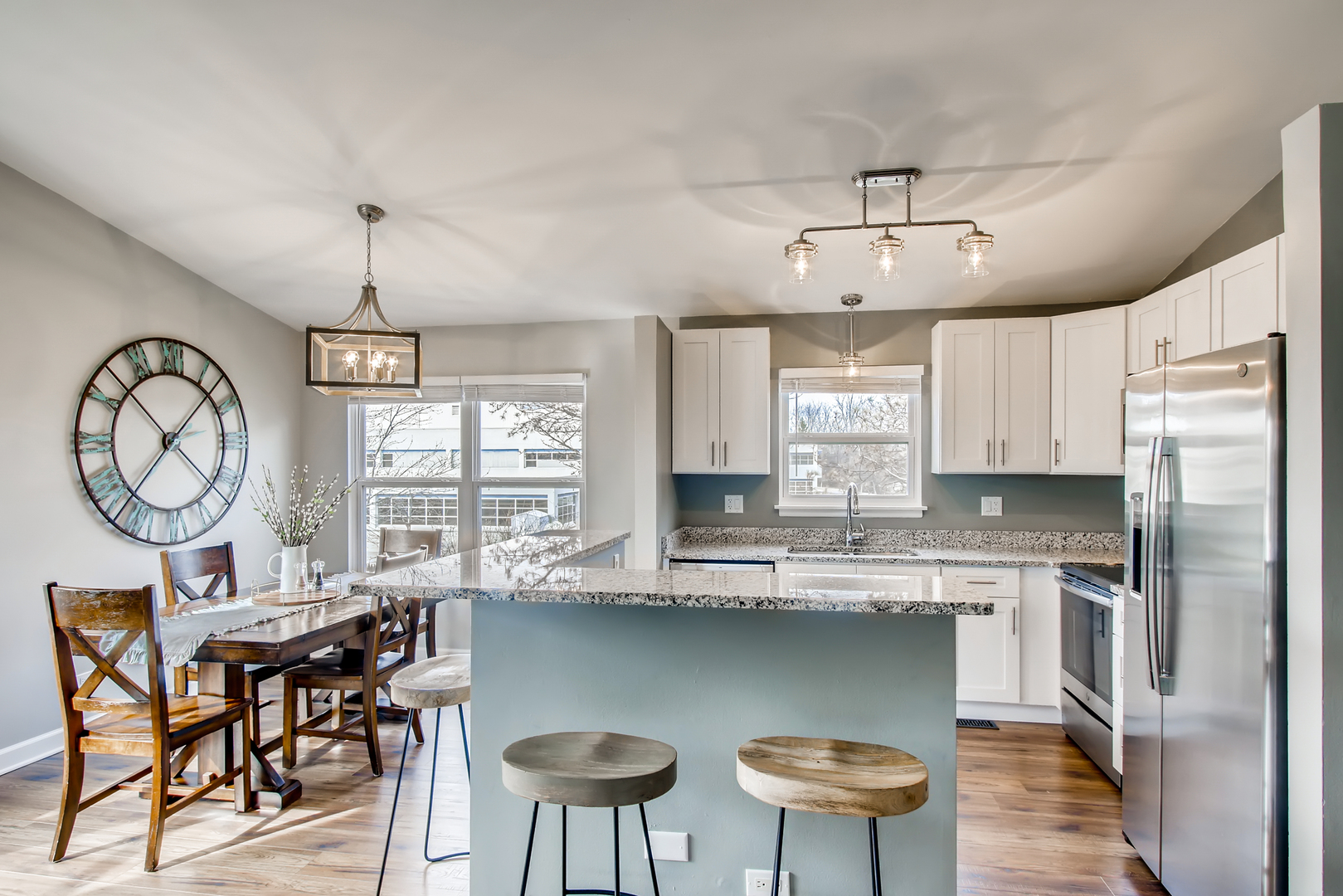 140 West Golf Road, Unit B Libertyville, IL 60048 - Photo 2 of 14 a kitchen with stainless steel appliances granite countertop a stove a refrigerator a sink dishwasher a dining table and chairs with wooden floor