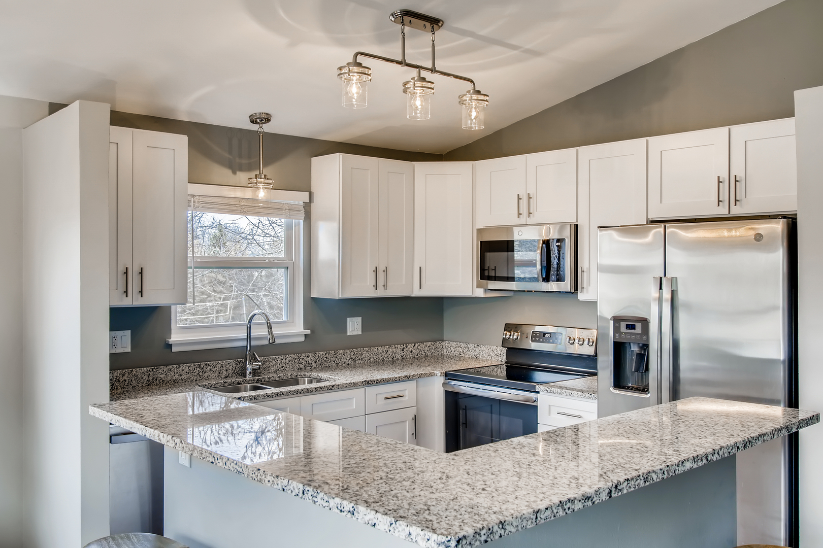140 West Golf Road, Unit B Libertyville, IL 60048 - Photo 3 of 14 a kitchen with stainless steel appliances granite countertop a sink refrigerator and microwave