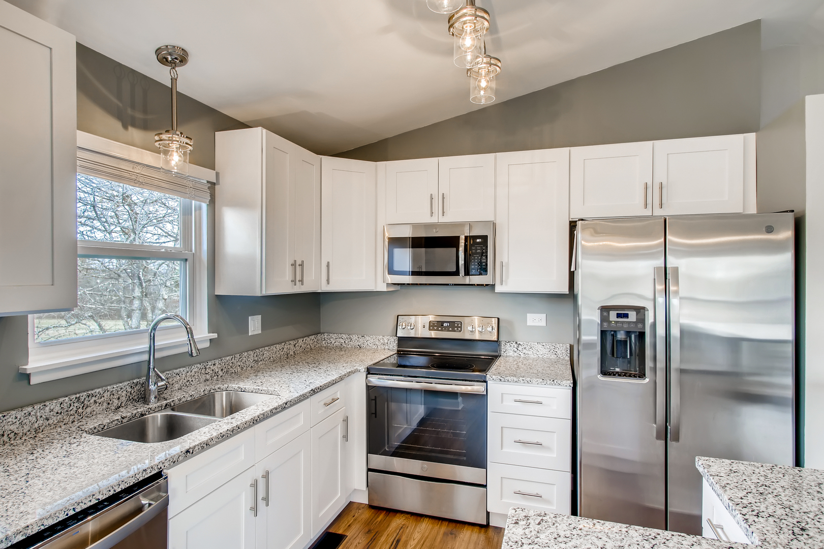 140 West Golf Road, Unit B Libertyville, IL 60048 - Photo 4 of 14 a kitchen with granite countertop a refrigerator stove and microwave