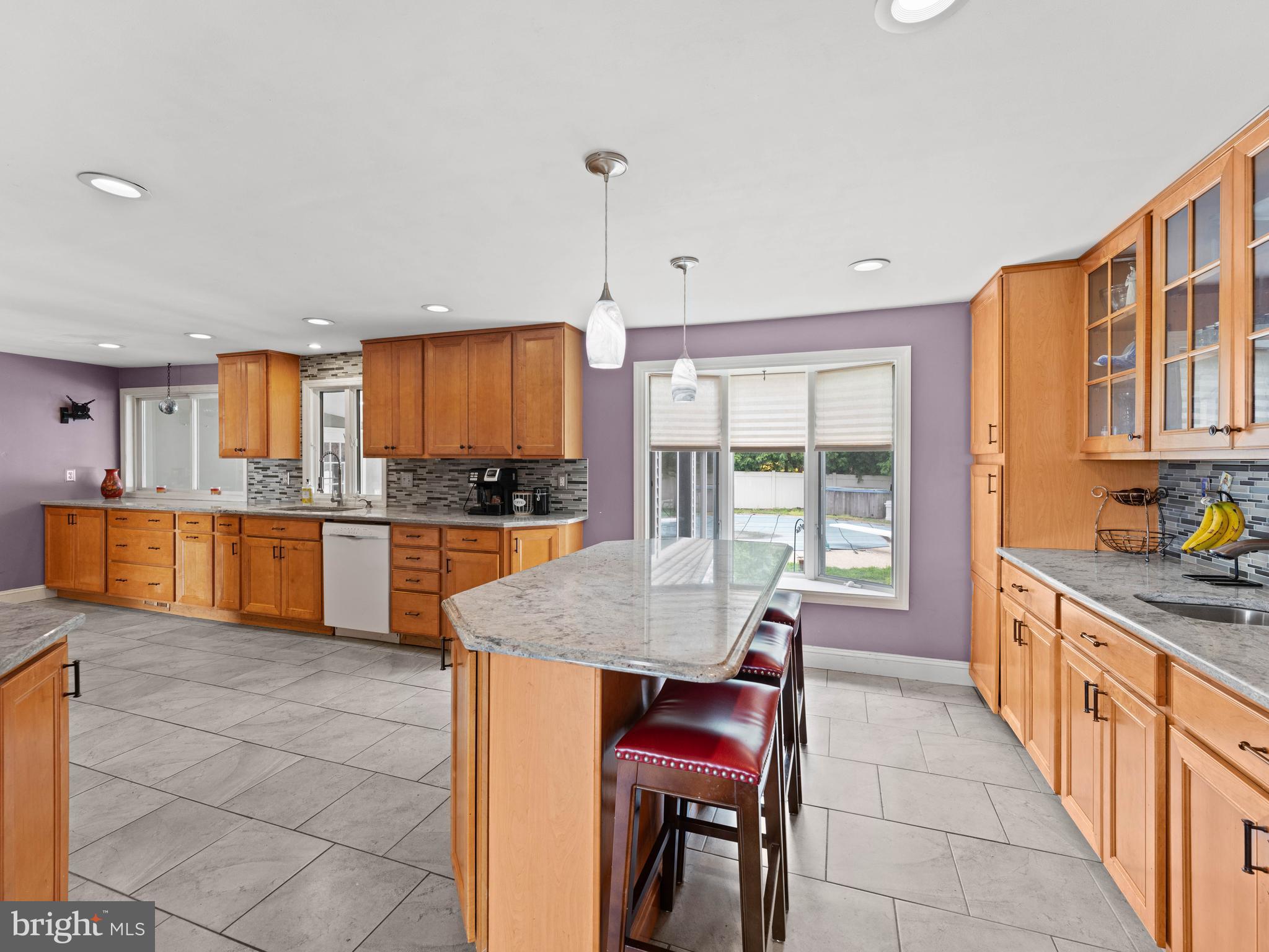 2505 Yellowstone Road Cinnaminson, NJ 08077 - Photo 26 of 40 a kitchen with stainless steel appliances granite countertop a stove top oven a sink dishwasher a dining table and chairs with wooden floor