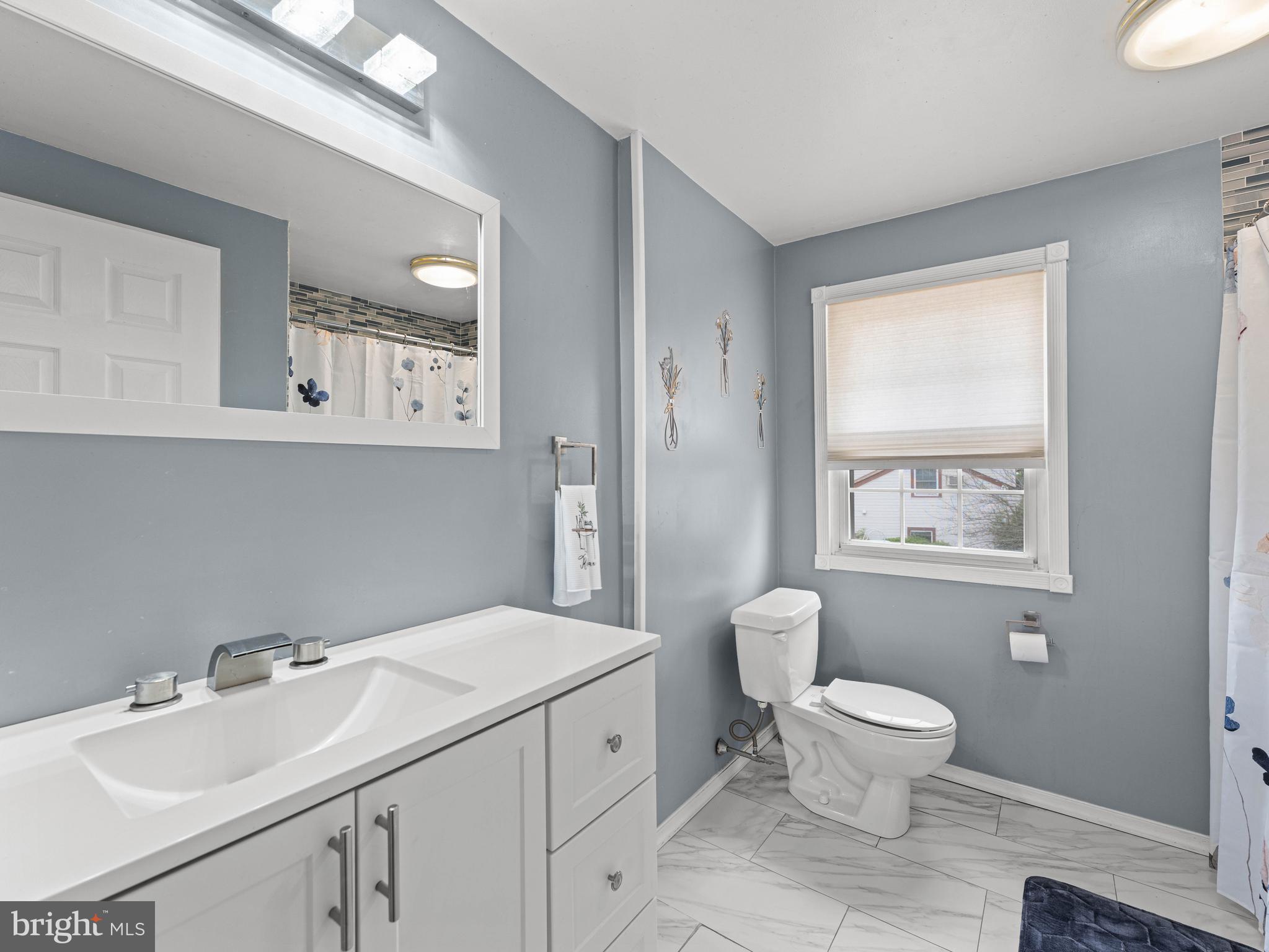 2505 Yellowstone Road Cinnaminson, NJ 08077 - Photo 10 of 40 a bathroom with a toilet sink and mirror