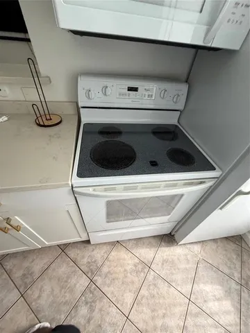 a stove top oven sitting inside of a kitchen