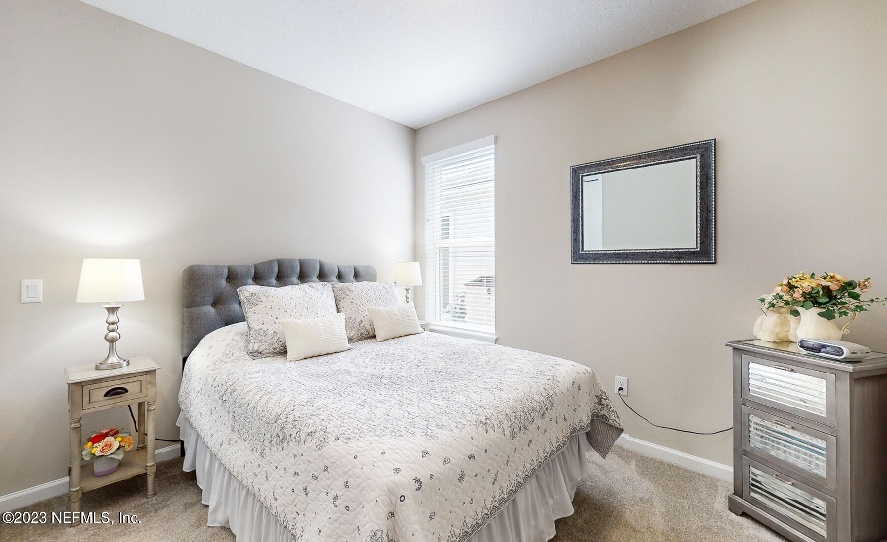 1113 Rustic Ml Drive St. Augustine, FL 32092 - Photo 16 of 62 a bedroom with a bed and a lamp on the dresser