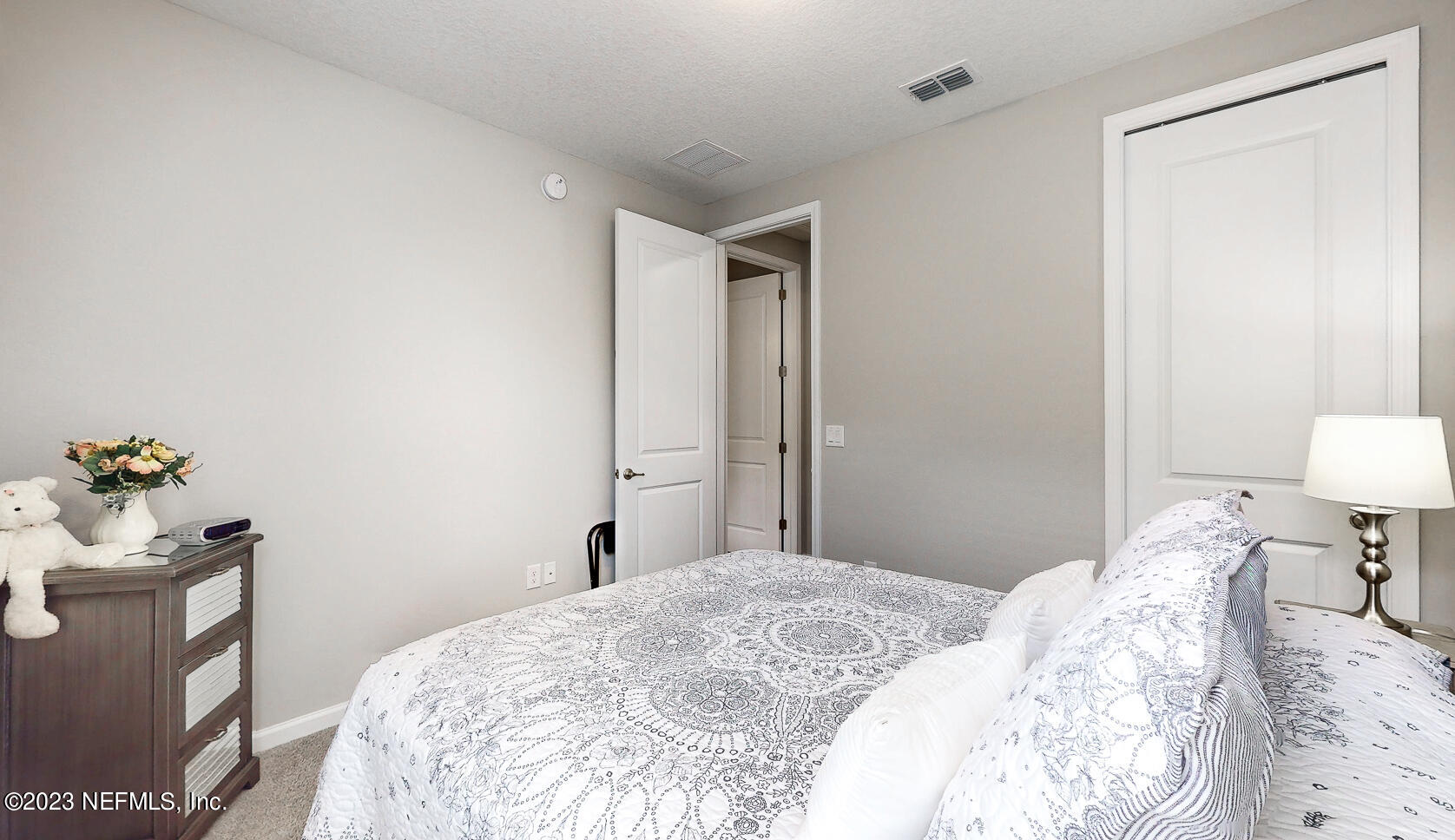 1113 Rustic Ml Drive St. Augustine, FL 32092 - Photo 17 of 62 a bedroom with a bed and a table in it