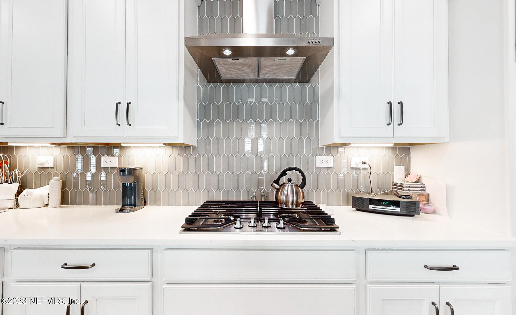1113 Rustic Ml Drive St. Augustine, FL 32092 - Photo 10 of 62 a kitchen with a stove and white cabinets
