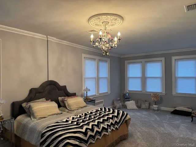 a bedroom with bed and a window