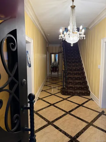 a view of a livingroom with furniture staircase and kitchen view