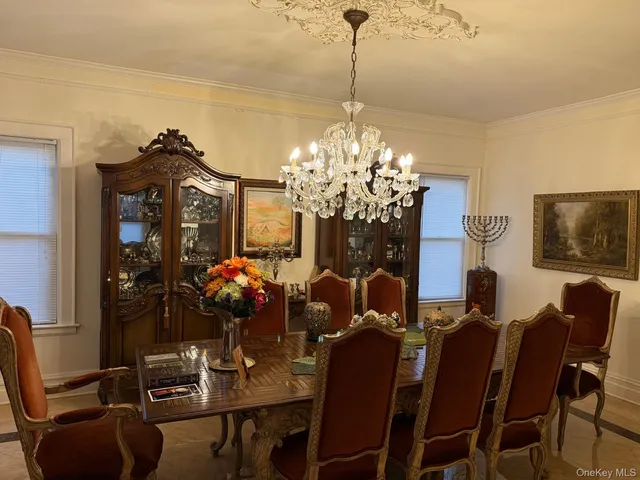 a view of a dining room with furniture and chandelier