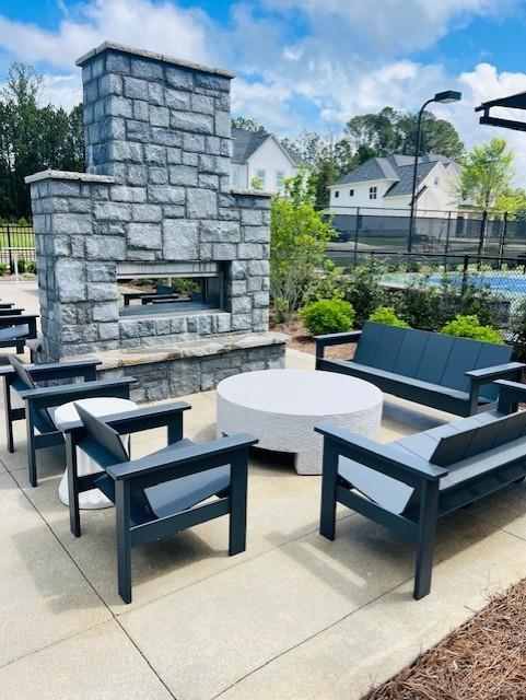 6440 Durnwald Way Cumming, GA 30028 - Photo 17 of 19 a view of a patio with a table and chairs