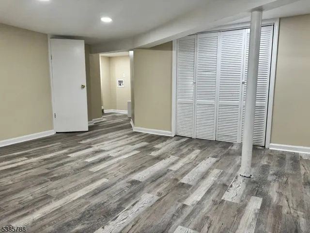 an empty room with wooden floor and white doors