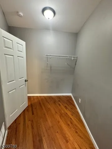 a view of a room with wooden floor and white walls