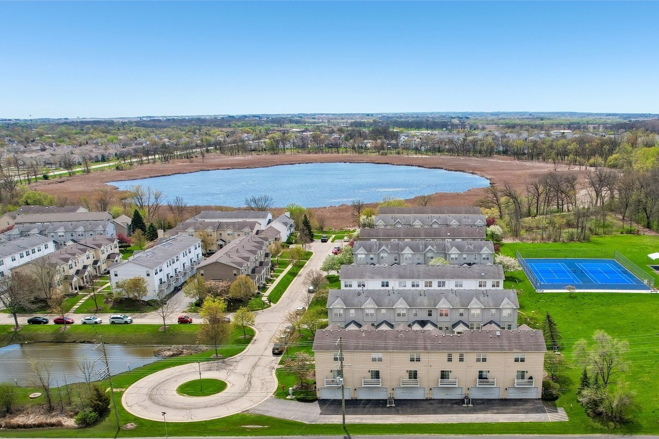 626 Triumph Court Hainesville, IL 60073 - Photo 2 of 32 an aerial view of a house with a garden and lake view