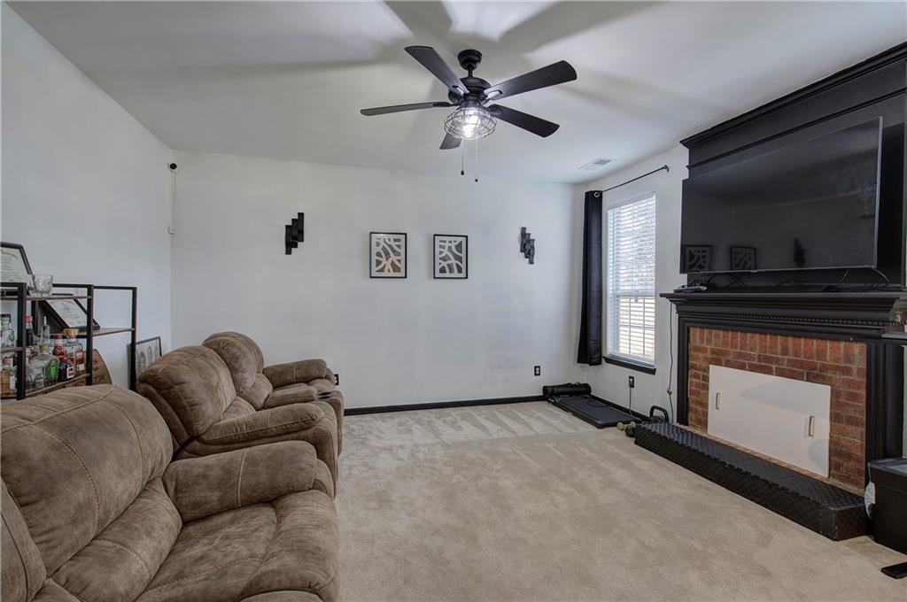 4508 Howell Farms Road Northwest Acworth, GA 30101 - Photo 16 of 42 a living room with furniture a flat screen tv and a fireplace