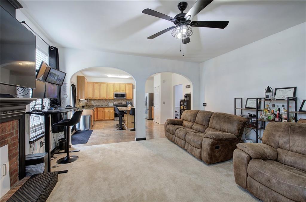 4508 Howell Farms Road Northwest Acworth, GA 30101 - Photo 17 of 42 a living room with furniture a ceiling fan and a rug