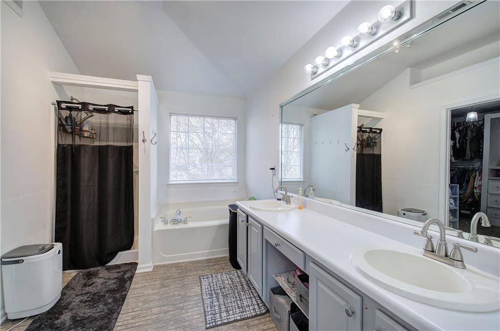 4508 Howell Farms Road Northwest Acworth, GA 30101 - Photo 23 of 42 a bathroom with a double vanity sink a toilet and a mirror
