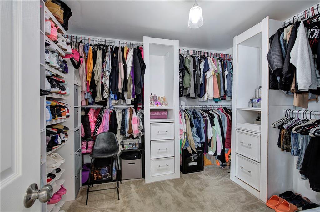 4508 Howell Farms Road Northwest Acworth, GA 30101 - Photo 25 of 42 a view of walk in closet with clothes and shoes