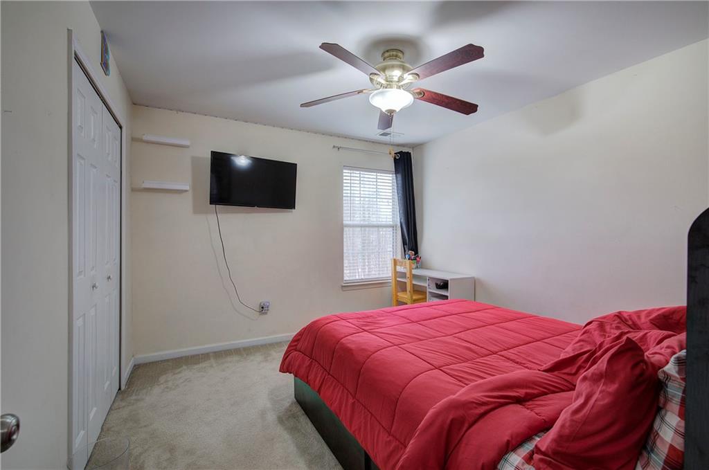 4508 Howell Farms Road Northwest Acworth, GA 30101 - Photo 28 of 42 a bedroom with a large bed and a flat screen tv