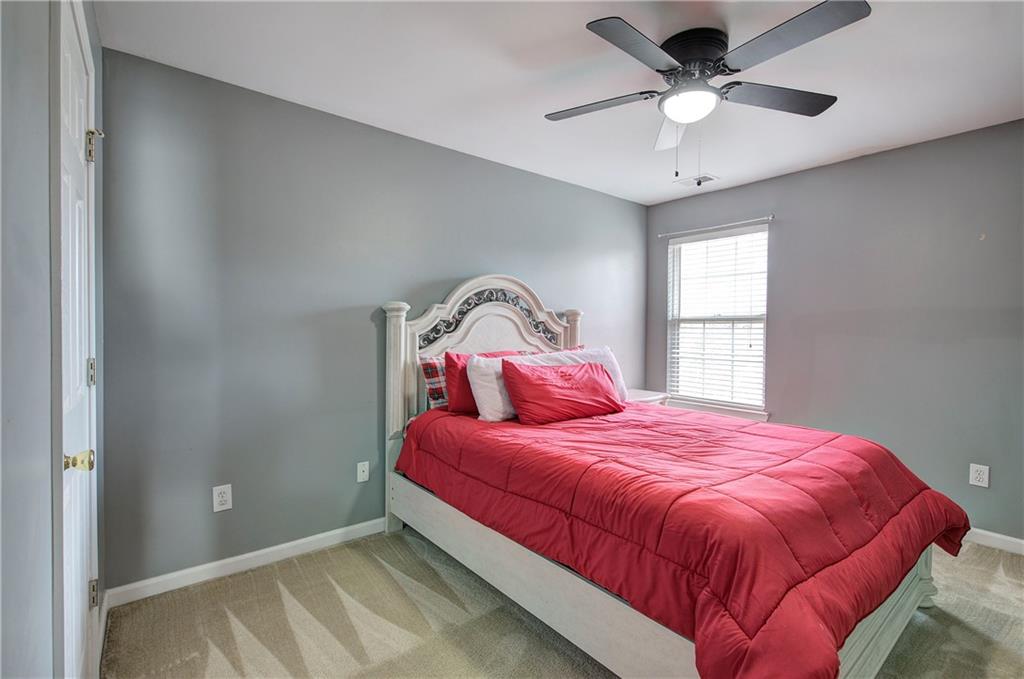 4508 Howell Farms Road Northwest Acworth, GA 30101 - Photo 29 of 42 a bedroom with a large bed and a chandelier
