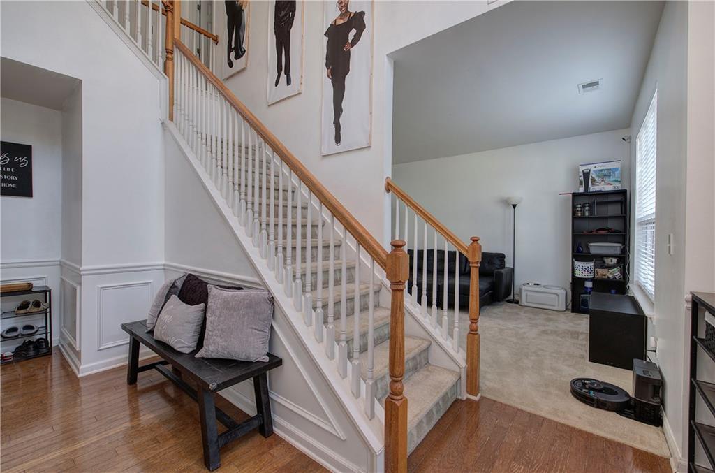 4508 Howell Farms Road Northwest Acworth, GA 30101 - Photo 6 of 42 a view of staircase with lots of furniture and wooden floor