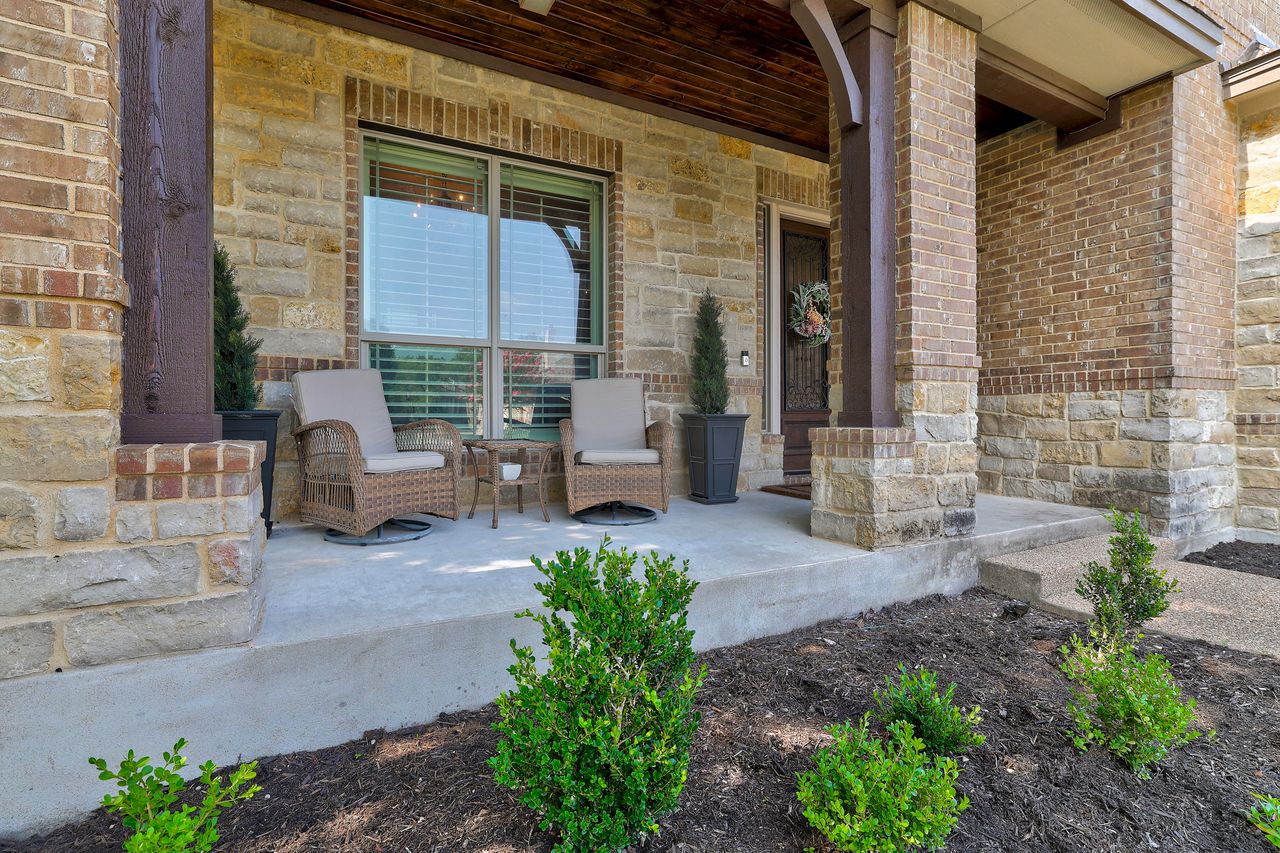 809 Prairie Dunes Drive Georgetown, TX 78628 - Photo 2 of 40 A welcoming front porch features sturdy brick and stone construction, inviting relaxation.