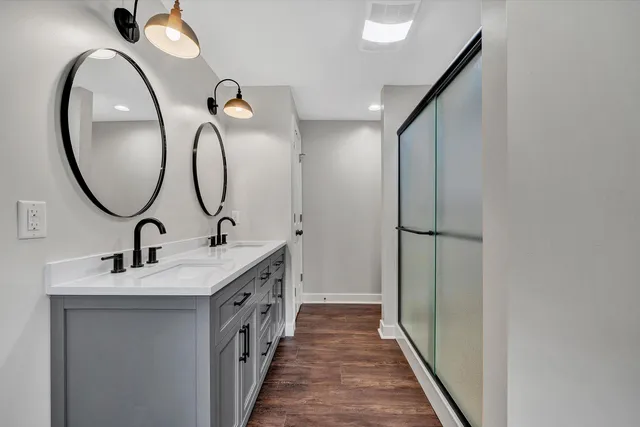 a bathroom with a double vanity sink and a mirror