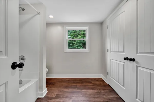 a view of a bathroom with a tub and sink