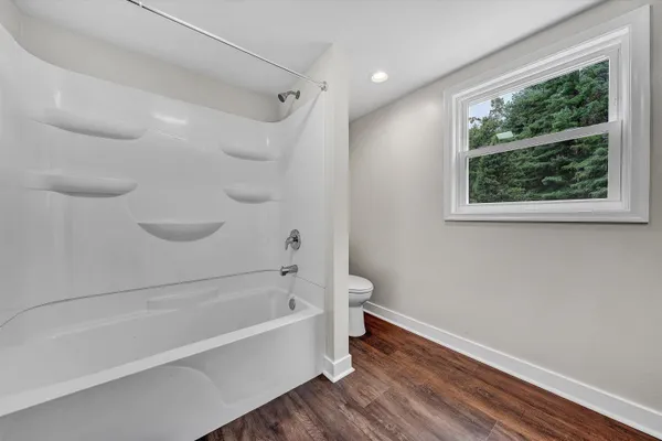 a bathroom with a bathtub and a shower