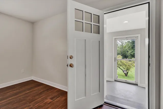 a view of hallway with wooden floor and front door