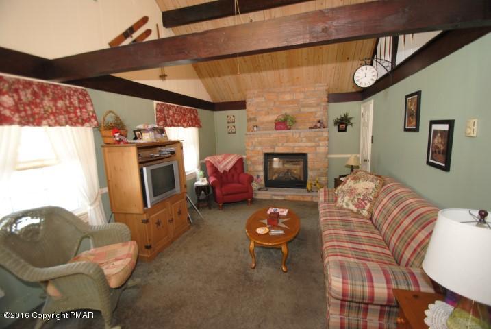 90 Highridge Road Albrightsville, PA 18210 - Photo 2 of 30 a living room with furniture a fireplace and a window