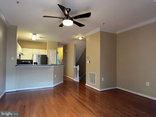 a view of a kitchen with a sink and a large window