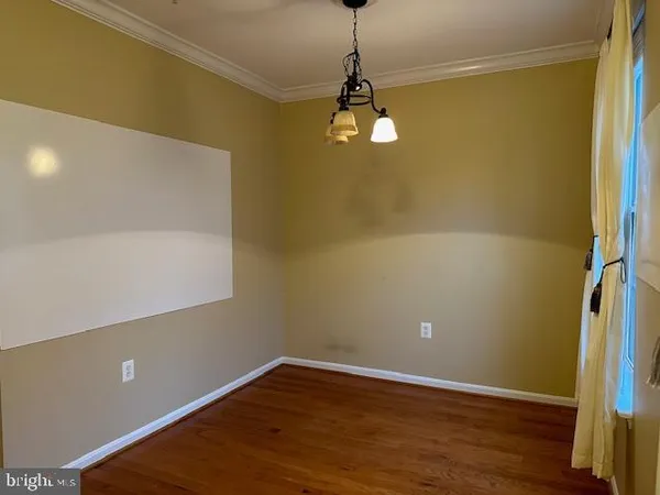 a view of a room with wooden floor and fan