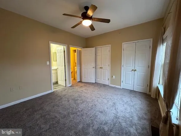 a view of empty room with ceiling fan